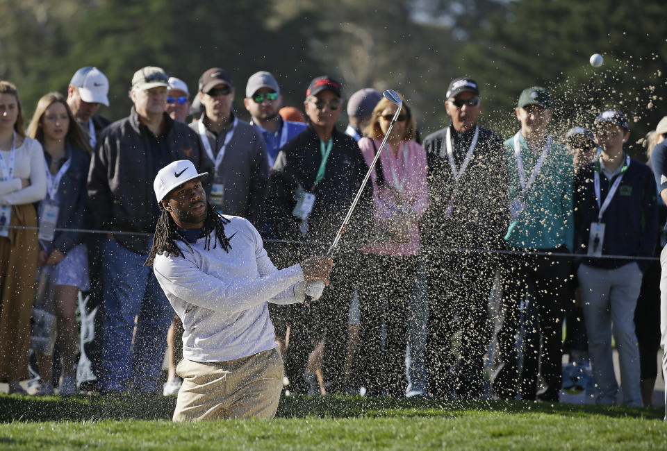 Larry Fitzgerald follows his shot out of a bunker onto the second green of the Pebble Beach Golf Links at last weekend's pro-am. (AP)