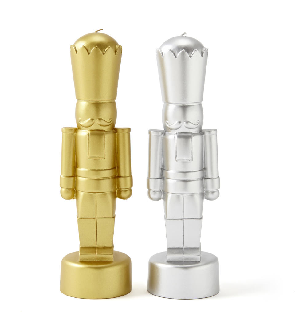 In this photo provided by JCPenney, stylized nutcrackers in gold and silver are actually candles, from Jonathan Adler’s holiday collection. Following the general trend in home decor, holiday trim and accessories this year are a mix of eclectic and traditional colors and styles. Style watchers say we’re approaching the holidays with a more open mind, and decor has never been more expansive in terms of what works. (AP Photo/JCPenney)