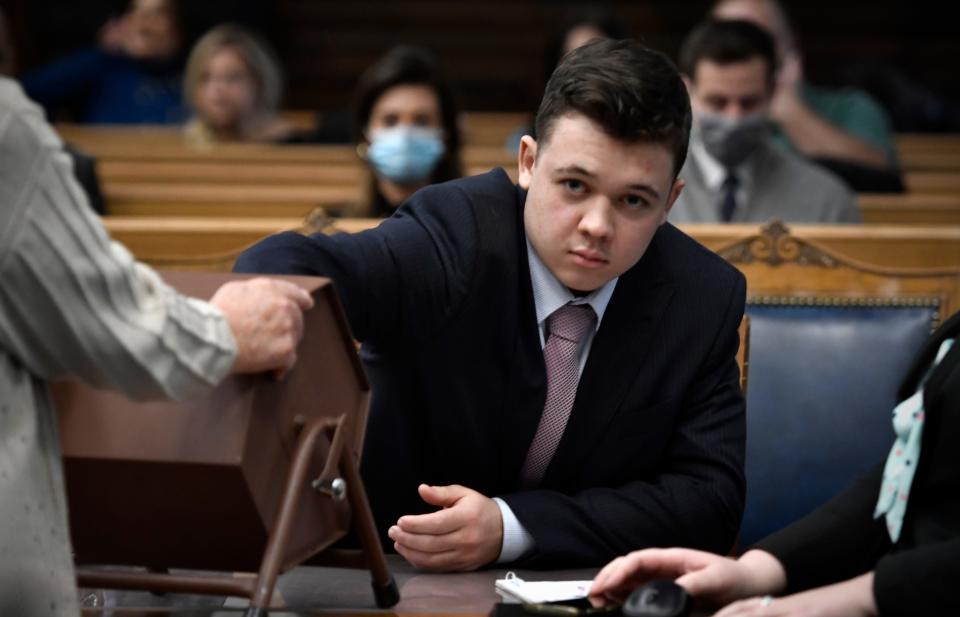 Kyle Rittenhouse pulls numbers of jurors out of a tumbler during his trial at the Kenosha County Courthouse in Kenosha, Wis., on Tuesday, Nov. 16, 2021. The jurors selected through this process will not participate in deliberations.