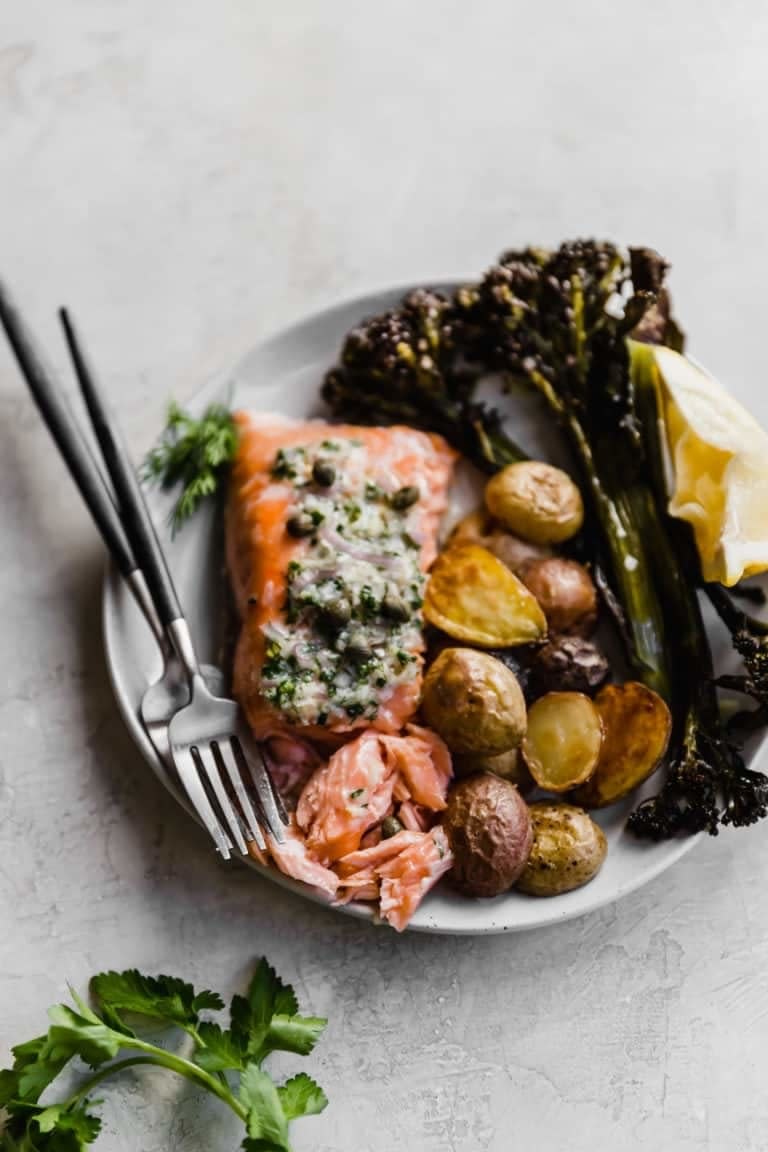 Salmon with potatoes and baby broccoli.