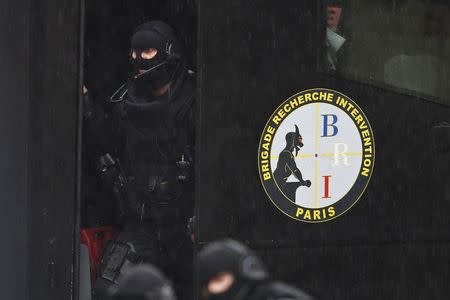 Members of French special police forces of Research and Intervention Brigade (BRI) are seen at the scene of a shooting in the street of Montrouge near Paris January 8, 2015. REUTERS/Charles Platiau