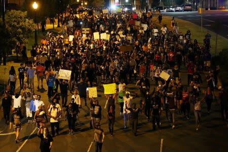 Demonstrators march outside the downtown streets protesting the police shooting of Keith Scott in Charlotte, North Carolina, U.S., September 24, 2016. REUTERS/Mike Blake