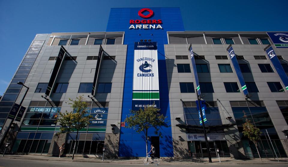 A cyclist rides past Rogers Arena, the home of the Vancouver Canucks NHL hockey team, in Vancouver, British Columbia, on Sunday Sept. 16, 2012. The NHL locked out its players at midnight Saturday, the fourth shutdown for the NHL since 1992, including a year-long dispute that forced the cancellation of the entire 2004-05 season. (AP Photo/The Canadian Press, Darryl Dyck)