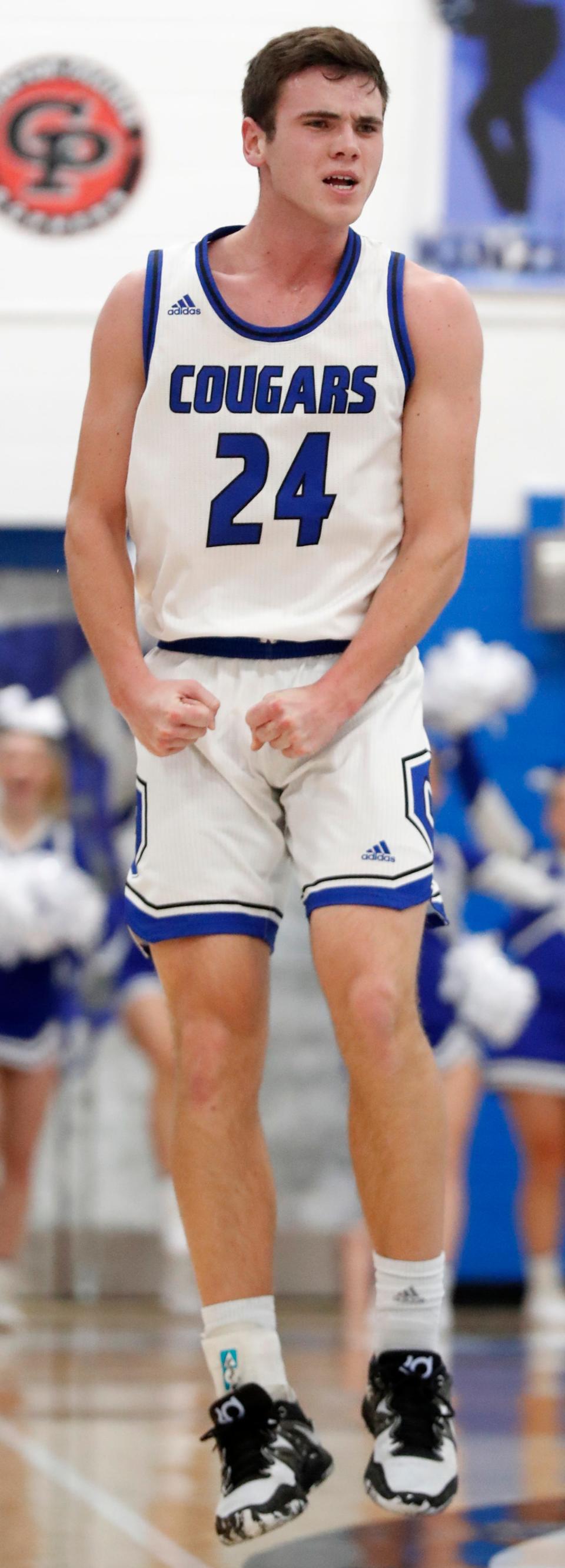 Carroll Cougars Jake Skinner (24) reacts to making a shot during the IHSAA boy’s basketball game against the Taylor Titans, Friday, Feb. 17, 2023, at Carroll High School in Flora, Ind. Carroll won 59-54.