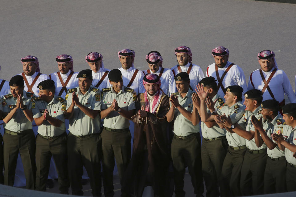 Jordan's Crown Prince Hussein, center, participates in a celebration in Amman, Jordan, Wednesday, May 31, 2023, a day before his wedding to Saudi architect Rajwa Alseif. (AP Photo/Raad Adayleh)