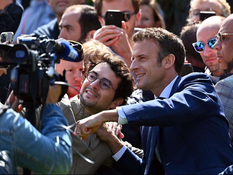 Emmanuel Macron meets voters as he leaves his house to vote (Getty Images)