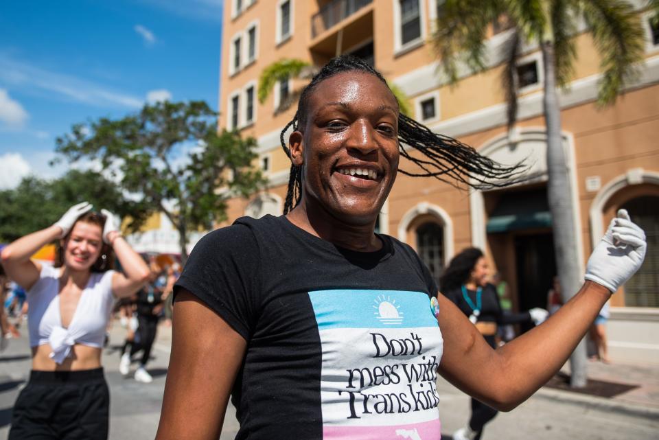 A dancer performing in the Palm Beach Pride Parade smiles while passing by on Sunday, March 26, 2023, in downtown Lake Worth Beach, FL. Thousands attended the parade, which featured dozens of floats, officials and groups celebrating Pride while marching east along Lake Avenue to Bryant Park.