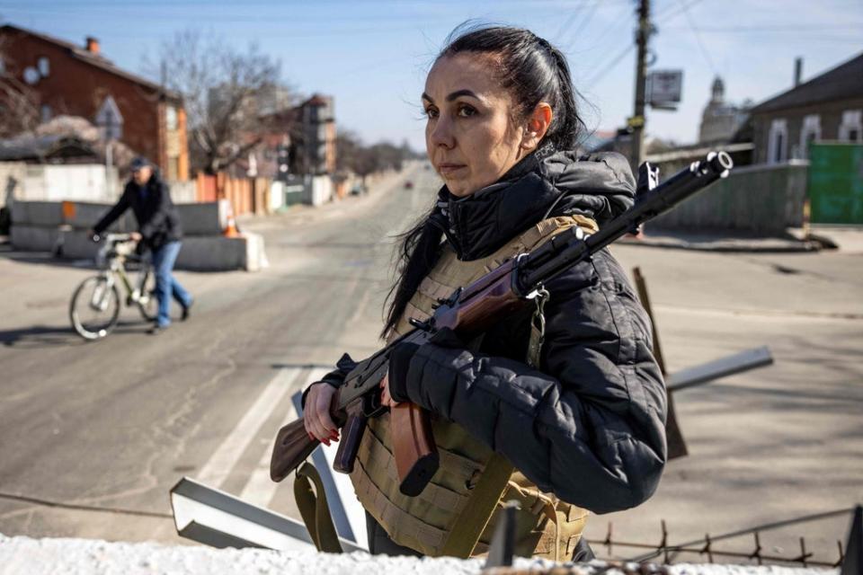 A volunteer takes position at a checkpoint in a district in Kyiv, on March 20, 2022 (AFP via Getty Images)