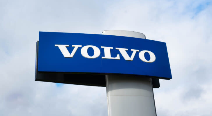 Photo of blue and white Volvo (VLVLY) logo on a car dealership sign with light and cloudy background