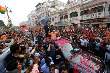 India's Prime Minister Narendra Modi waves towards his supporters during a roadshow in Varanasi, India, April 25, 2019. REUTERS/Adnan Abidi