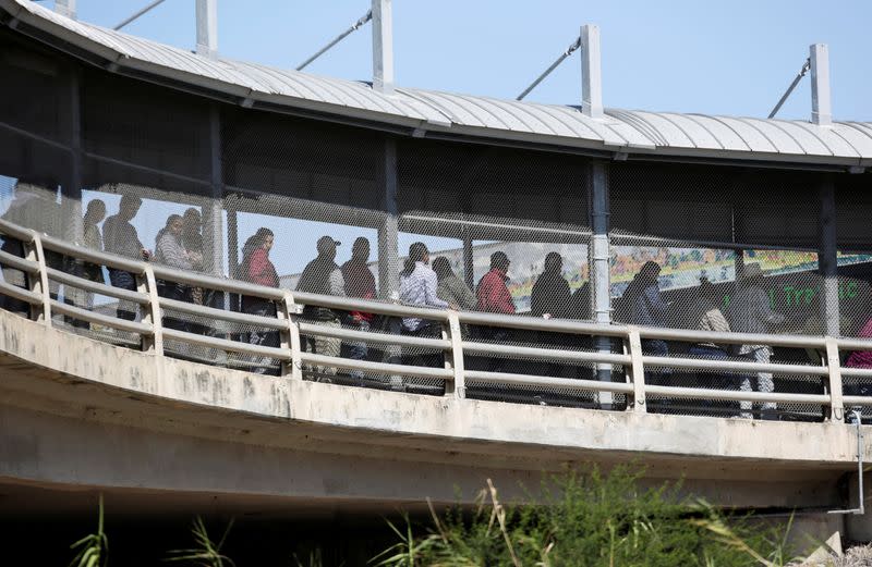 People queue to cross into U.S. at Brownsville-Matamoros Internacional Bridge, as seen from Matamoros, Mexico