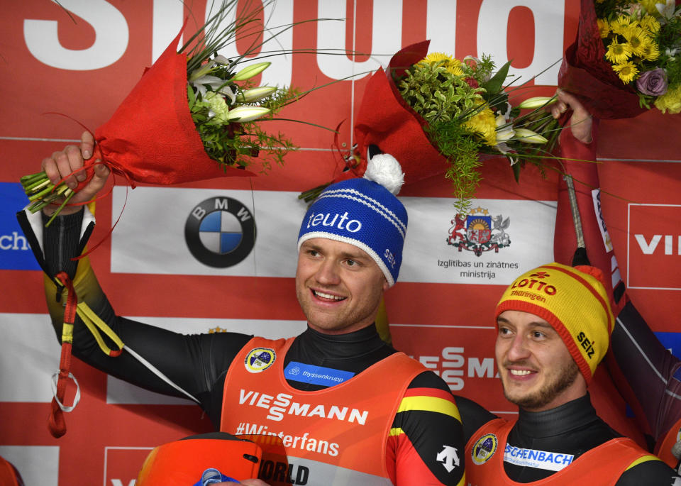 Toni Eggert and Sascha Benecken of Germany celebrate after finishing first in a men's doubles race at the Luge World Cup event in Sigulda, Latvia, Saturday, Jan. 12, 2019. (AP Photo/Roman Koksarov)