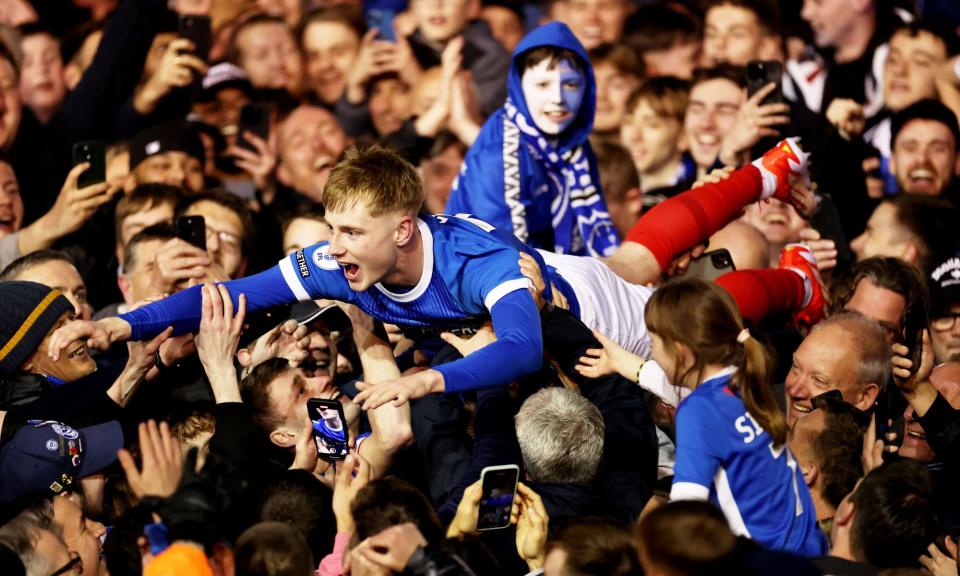 <span>Portsmouth’s Paddy Lane does some crowd surfing at full-time. </span><span>Photograph: James Marsh/Shutterstock</span>