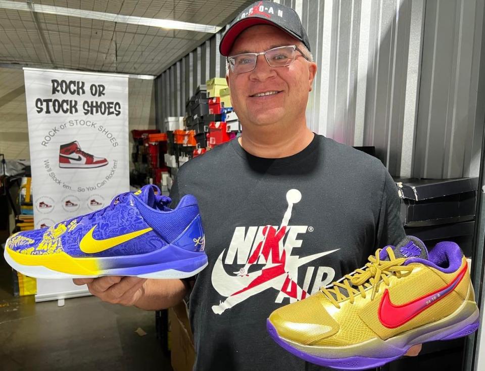 John Hray, coordinator of the Stark County Sneaker and Clothing XPO, holds two of the hundreds of Nike athletic shoes that will be for sale during the event Sunday at the Canton Memorial Civic Center.