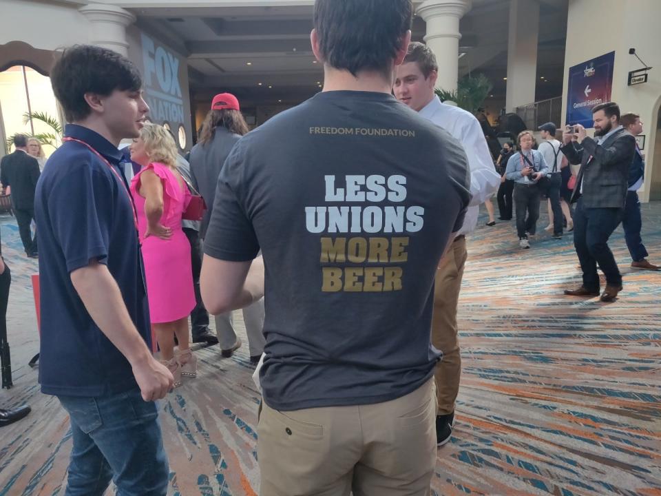 CPAC attendee wears a T-shirt that reads, "Less unions, more beer."