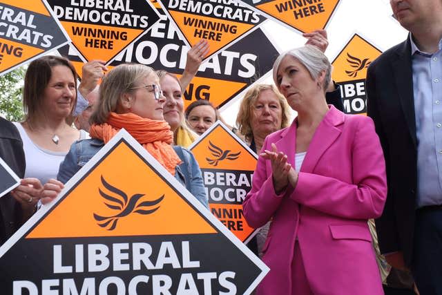 Lib Dem deputy leader Daisy Cooper with activists holding  Lib Dem placards