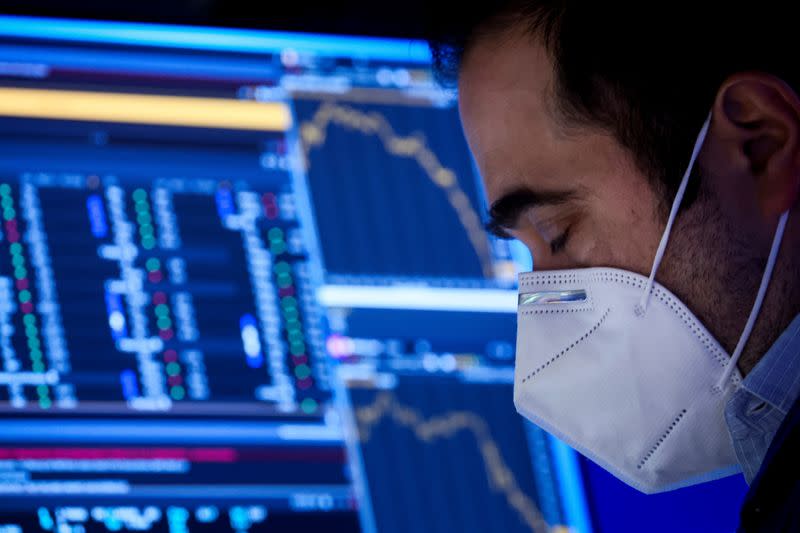 A Specialist Trader works inside his post on the floor of the NYSE in New York