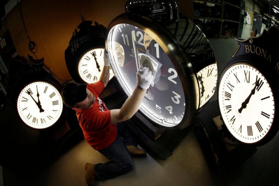 Dan LaMoore wipes down a Shinola clock at Electric Time Co., in Medfield, MA. The time shift, also referred to as “spring forward, fall back,” will happen at 2 a.m. Sunday, March 10.