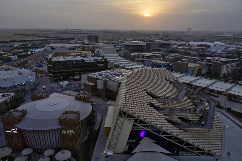 The South Korea and Hungary pavilions are seen at sunset at Expo 2020, in Dubai, United Arab Emirates, Sunday, Oct. 3, 2021. (AP Photo/Jon Gambrell)
