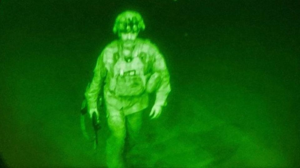 U.S. Army Major General Chris Donahue, commander of the 82nd Airborne Division, steps on board a C-17 transport plane