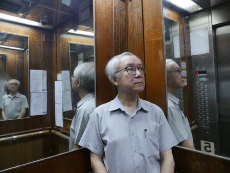 Landlord Ng Goon-lau, 66, poses inside a lift of a building where two suicides have taken place in his property, in Hong Kong, China June 8, 2018. Picture taken June 8, 2018. REUTERS/Venus Wu