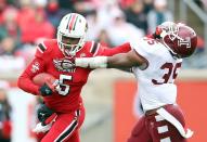 Teddy Bridgewater #7 of the Louisville Cardinals runs with the ball while defended by Nate Smith #35 of the Temple Owls during the game at Papa John's Cardinal Stadium on November 3, 2012 in Louisville, Kentucky. (Photo by Andy Lyons/Getty Images)