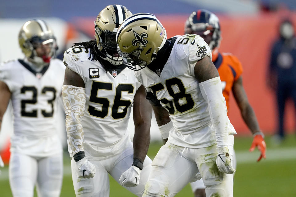 New Orleans Saints outside linebacker Demario Davis (56) and outside linebacker Kwon Alexander (58) celebrates a defensive stop against the Denver Broncos during the second half of an NFL football game, Sunday, Nov. 29, 2020, in Denver. (AP Photo/Jack Dempsey)