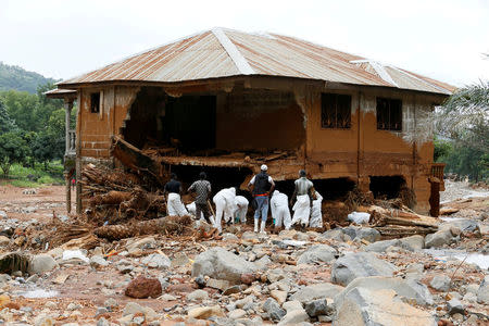 Rescue workers are seen searching through rubbles around a house for bodies at Pentagon, in Freetown, Sierra Leone August 18, 2017. REUTERS/Afolabi Sotunde TPX IMAGES OF THE DAY