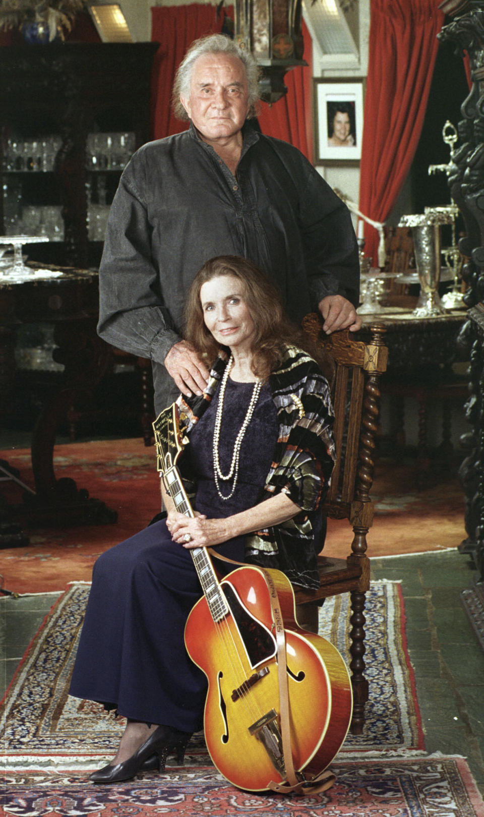 FILE - In this 1999, file photo, the late country music legend Johnny Cash poses with his wife, the late June Carter Cash, in their Hendersonville, Tenn., home. The Man in Black is about to get his own day in Arkansas. The Arkansas House on Tuesday, April 20, 2021, gave unanimous final approval to a bill that would make Feb. 26 "Johnny Cash Day," sending it to Gov. Asa Hutchinson, who plans to sign it. (AP Photo/Mark Humphrey/File)