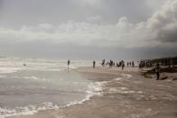 People watch waves at the beach as Hurricane Dorian makes its' way north, in St. Augustine