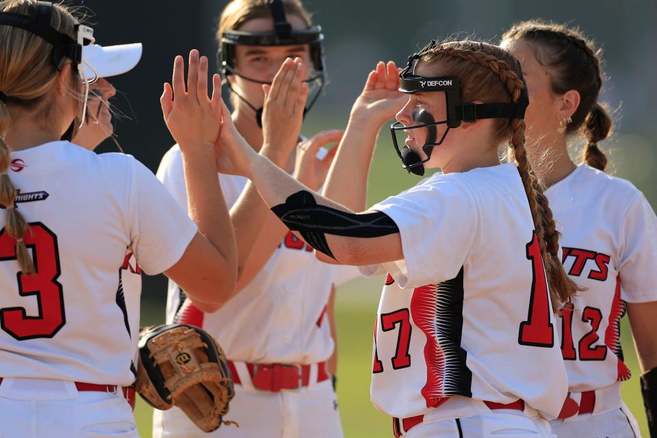 Creekside pitcher Kaylee Martineau (17) high-fives teammates before an April softball game against Providence.