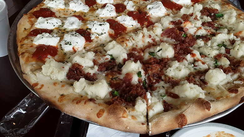 Mashed potato pizza pie being served