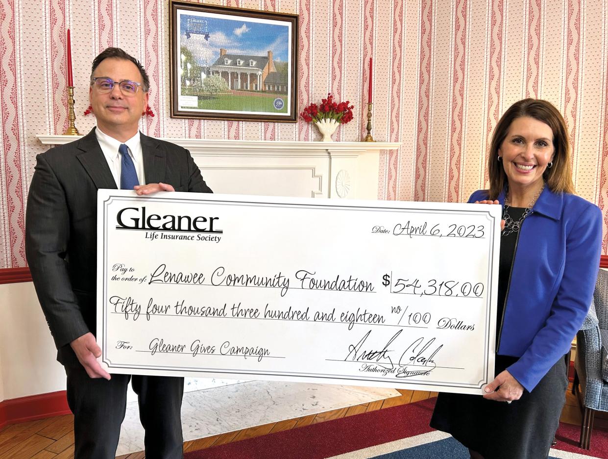 Gleaner Life Insurance Society President and CEO Anthony Clark, left, recently marked Gleaner’s donation of $54,318 through the Lenawee Cares program with Bronna Kahle, right, president and CEO of the Lenawee Community Foundation.