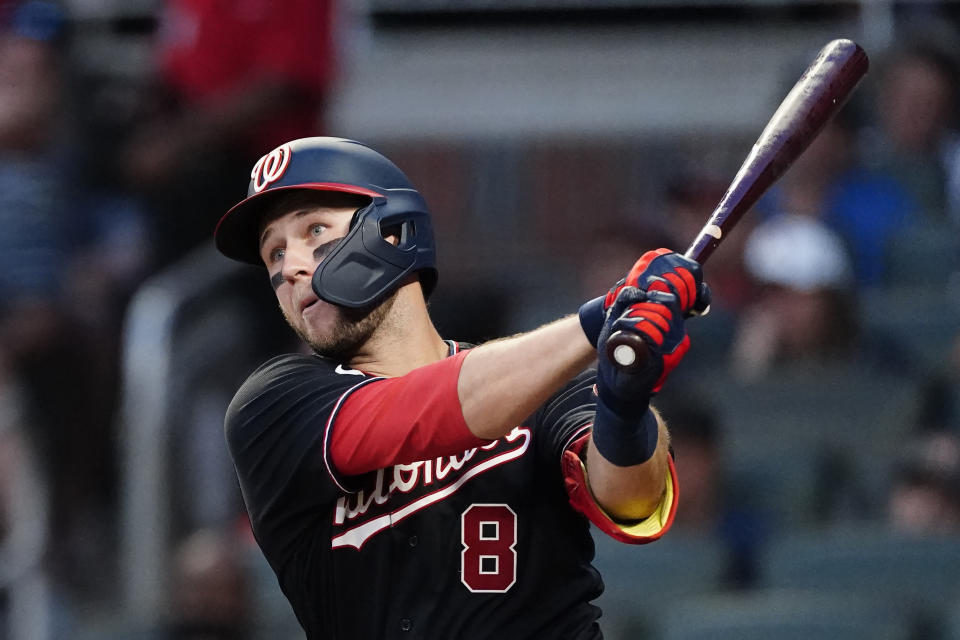 Washington Nationals' Carter Kieboom (8) drives in a run with a base hit in the fourth inning of a baseball game against the Atlanta Braves, Friday, Aug. 6, 2021, in Atlanta. (AP Photo/John Bazemore)