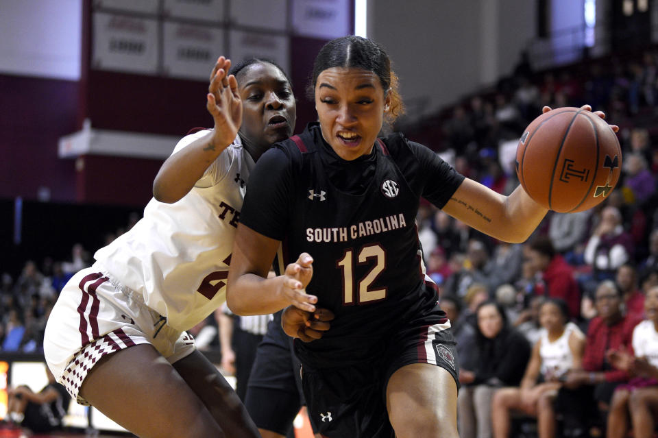 South Carolina's Breanna Beal, right, dribbles the ball past Temple's Asonah Alexander during the first half of an NCAA college basketball game, Saturday, Dec. 7, 2019, in Philadelphia. (AP Photo/Derik Hamilton)