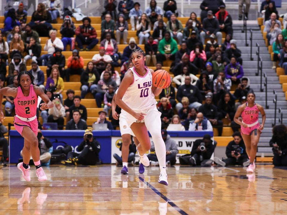LSU basketball player Angel Reese dribbles against Coppin State University in 2023.