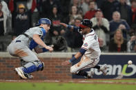 Los Angeles Dodgers catcher Will Smith can not make the tag on Atlanta Braves' Eddie Rosario scores on a single by Ozzie Albies in the eighth inning in Game 2 of baseball's National League Championship Series Sunday, Oct. 17, 2021, in Atlanta. (AP Photo/Ashley Landis)