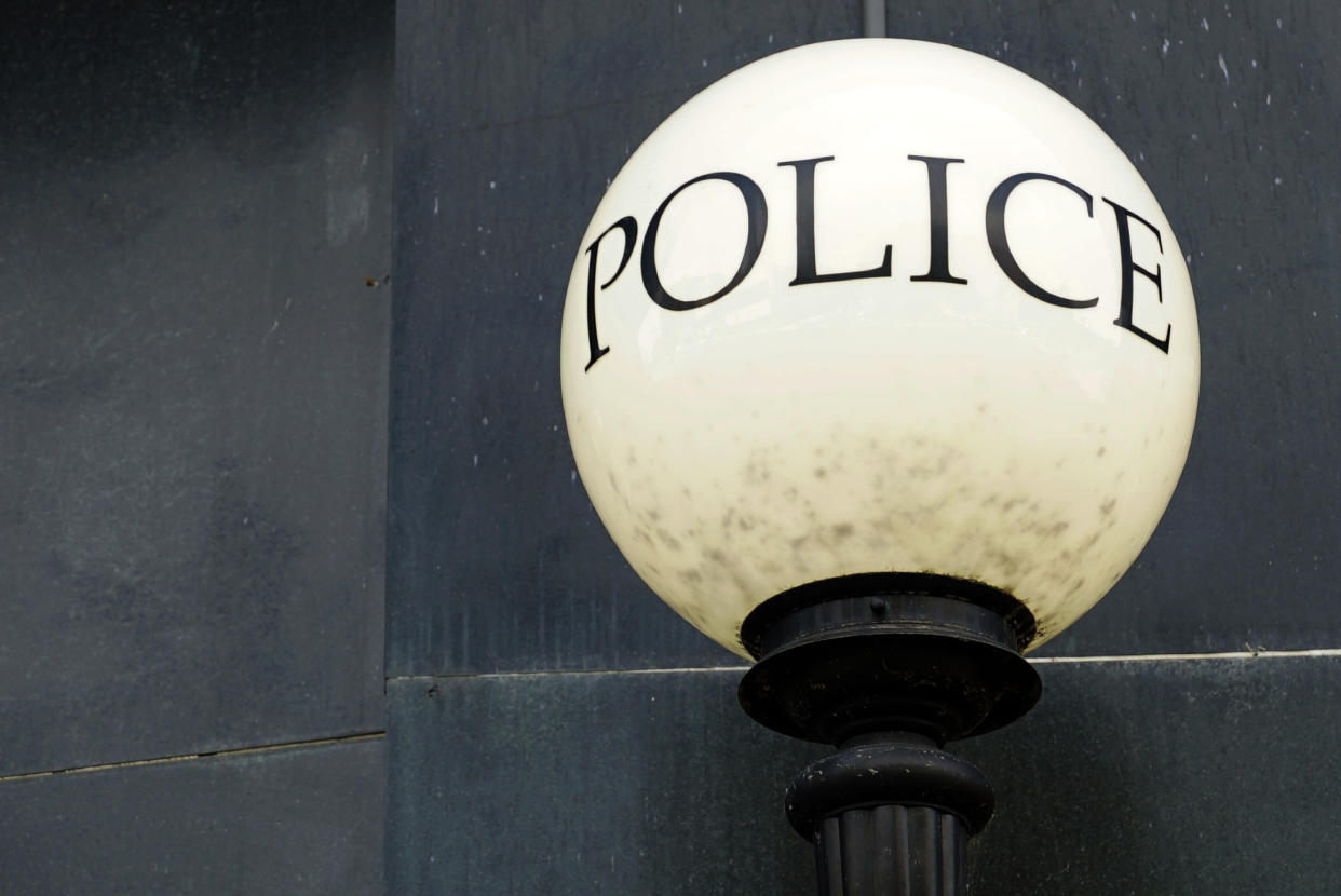 A lamp shines outside police headquarters in Greensboro, N.C., on Wednesday, June 22, 2022. The city recently let lapse its contract for Fog Reveal, a powerful cellphone-tracking tool that some advocates fear violates people's privacy rights. (AP Photo/Allen G. Breed)