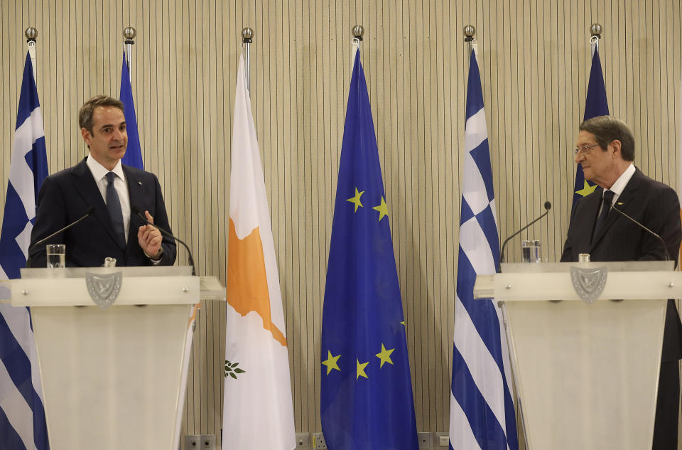 This image provided from Cyprus' press and information office, Cyprus President Nicos Anastasiades, right, and Greece's Prime minister Kyriakos Mitsotakis talk during a press conference after their meeting at the presidential palace in capital Nicosia, Cyprus, on Monday, Feb. 8, 2021. Mitsotakis is in Cyprus for one-day official visit. (Stavros Ioannides, PIO via AP)