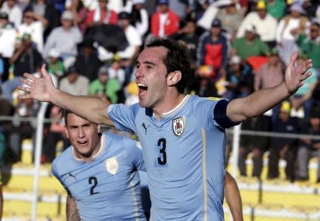 Diego Godin (R) of Uruguay celebrates with teammates after scoring against Bolivia during their 2018 World Cup qualifying soccer match at the Hernando Siles Stadium in La Paz, Bolivia October 8, 2015. REUTERS/David Mercado