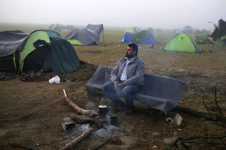 A man sits on the bench at a makeshift camp for migrants and refugees at the Greek-Macedonian border near the village of Idomeni, Greece, April 1, 2016. REUTERS/Marko Djurica