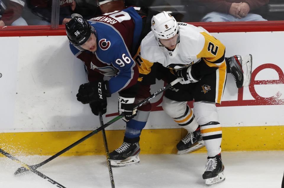 Pittsburgh Penguins defenseman Chad Ruhwedel, right, becomes entangled with Colorado Avalanche right wing Mikko Rantanen during the third period of an NHL hockey game Friday, Jan. 10, 2020, in Denver. Pittsburgh won 4-3 in overtime. (AP Photo/David Zalubowski)