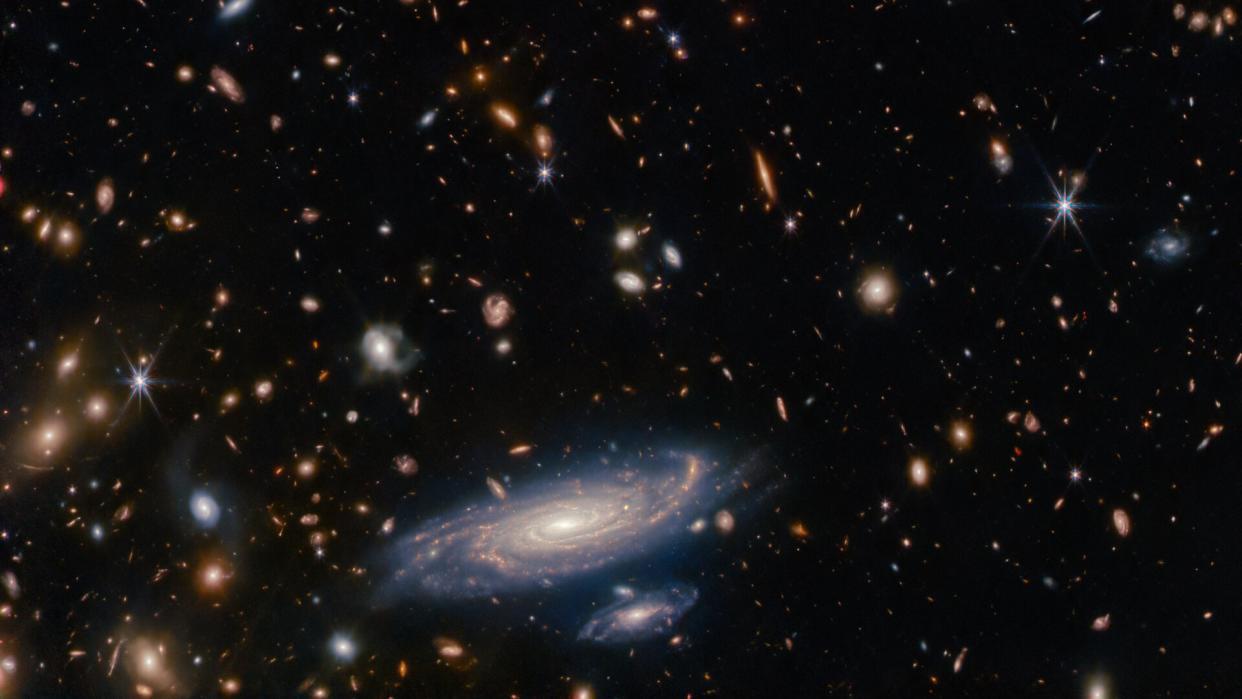  A image of a cavalcade of galaxies and stars taken by the James Webb Space Telescope shows a galaxy located 1 billion light-years away in stunning detail. 