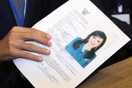 Thai Raksa Chart party leader Preechapol Pongpanich, holds up application of candidate for Prime Minister, Thailand's Princess Ubolratana Rajakanya Sirivadhana Barnavadi, at the election commission office in Bangkok, Thailand February 8, 2019. REUTERS/Athit Perawongmetha