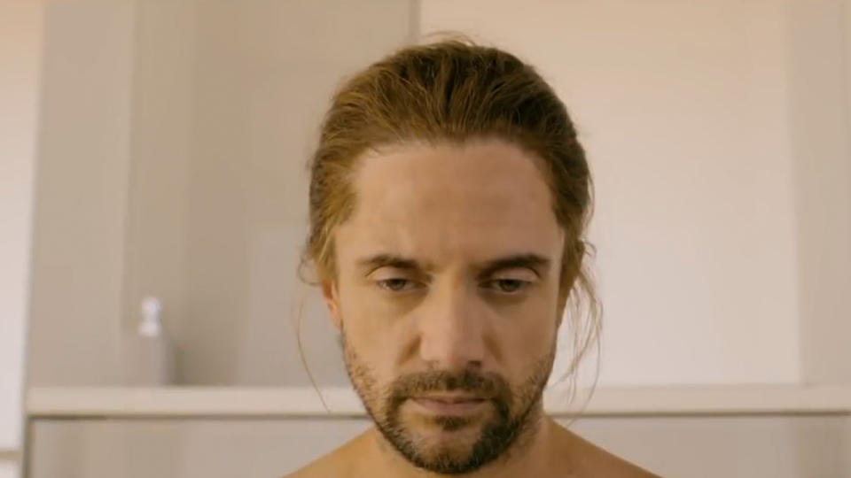 Close up of Topher Grace with long hair and a beard in Black Mirror