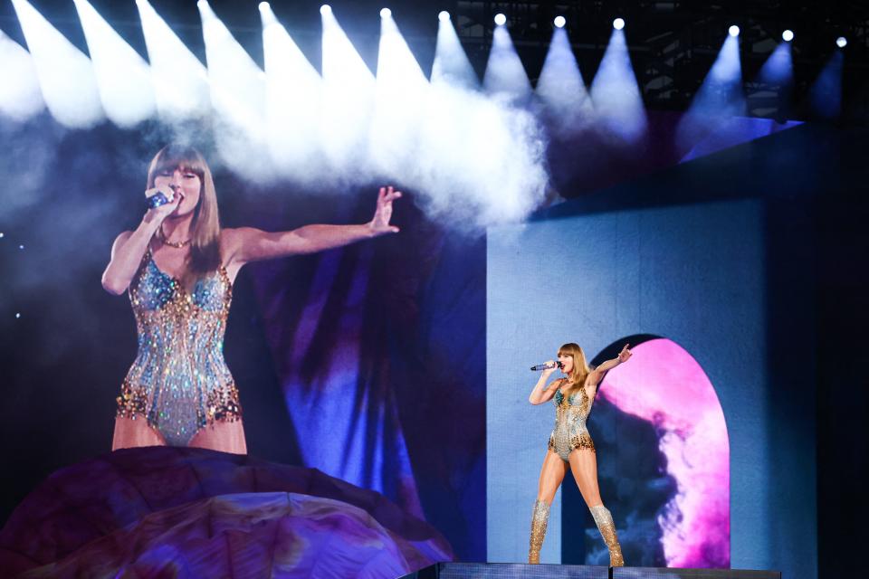 Taylor Swift performs on stage during a concert as part of her Eras World Tour in Sydney, Australia. Scott Swift, her father, has been accused of assaulting an Australian photographer after an incident on the Sydney waterfront.