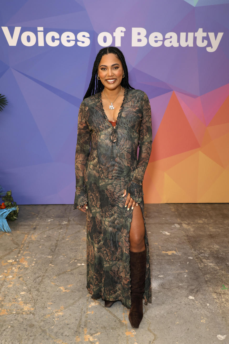 Ayesha Curry attends the The Voices Of Beauty Summit wearing brown mid-calf boots.