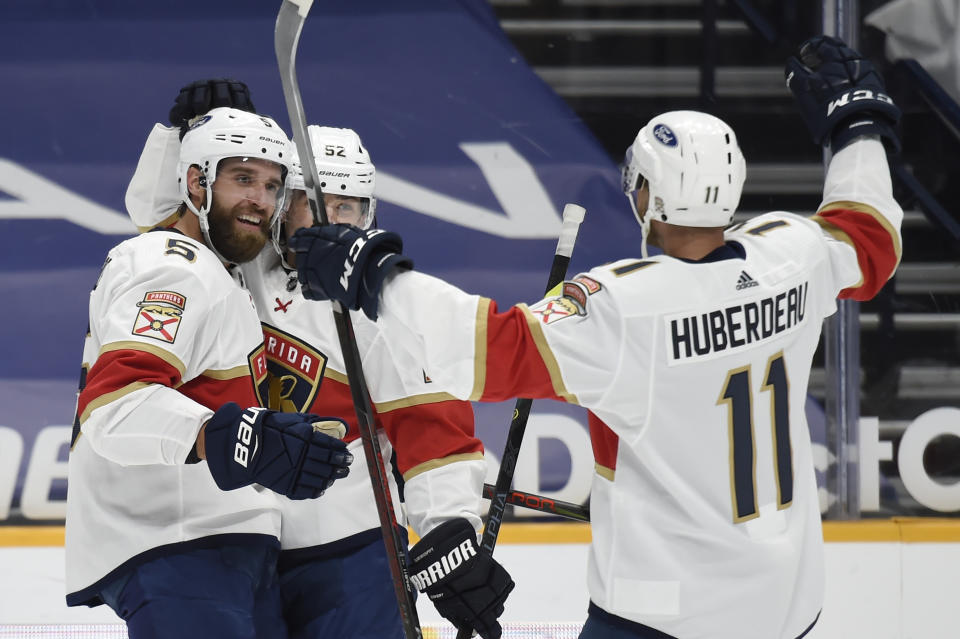 Florida Panthers defenseman Aaron Ekblad (5) celebrates with left-wing Jonathan Huberdeau (11) after Ekblad scored a goal against the Nashville Predators during the first period of an NHL hockey game Saturday, March 6, 2021, in Nashville, Tenn. (AP Photo/Mark Zaleski)