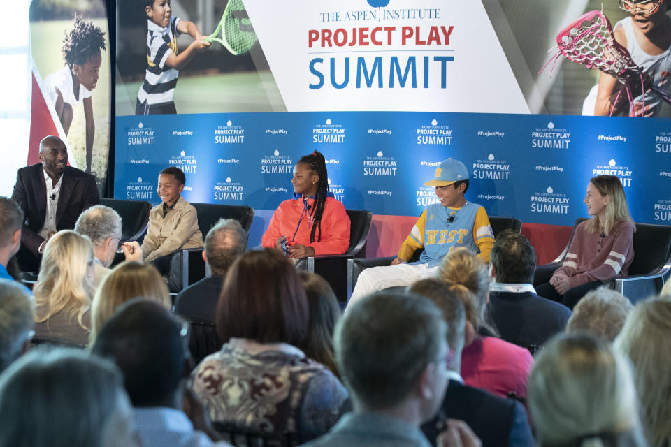 Former NBA basketball all-star Kobe Bryant, left, speaks as he moderates a panel about youth sports with Owen Norwood, 11, from Mobile, Ala., Shawkierra Mills, 12, from Detroit, Ka'olu Holt, 13, from Honolulu, and Zoe Barlow, 13, from Broken Arrow, Okla., during the Aspen Institute's Project Play Summit, Tuesday, Oct. 16, 2018 in Washington. (AP Photo/Alex Brandon)