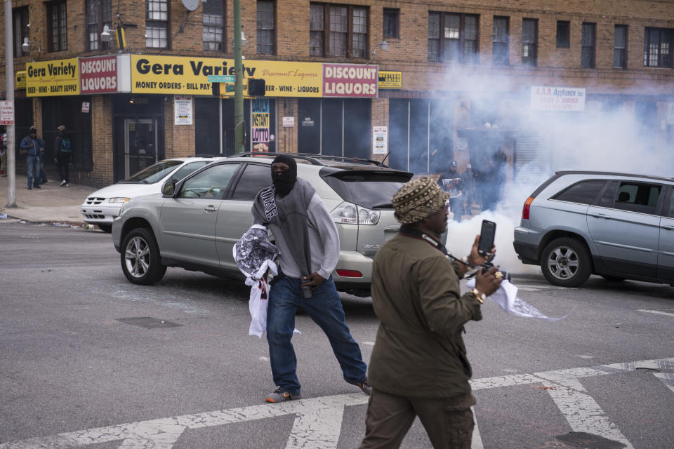 BALTIMORE, MD - APRIL 27: People run as smoke and tear gas is thrown during a protest for Freddie Gray near Mondawmin Mall in Baltimore, MD on Monday April 27, 2015. Gray died from spinal injuries about a week after he was arrested and transported in a police van. (Photo by Jabin Botsford/The Washington Post via Getty Images)